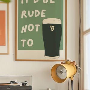 May include: A green poster with the text "It'd be rude not to" and a black and white illustration of a pint of beer.