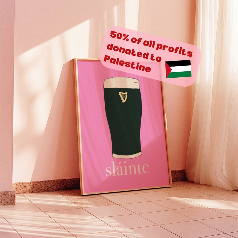 May include: A pink framed poster with a glass of dark beer and the text "sl&aacute;inte". The poster also includes the text "50% of all profits donated to Palestine" and a Palestinian flag.