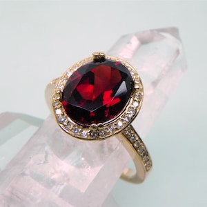AAAA  Pyrope Garnet   10x8mm  3 Carats  14K Yellow gold Halo engagement w/ .30 Cts of diamonds.  3013
