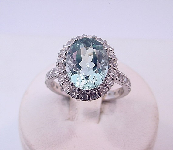 14K White Gold 10x8mm Oval Aquamarine & .06 CTW Diamond Halo Ring 14K White Gold 10x8mm Oval Aquamarine & .06 CTW Diamond Halo Ring
