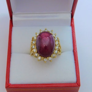 AAAA Star Ruby  16.76 carats  16x11mm  in 14K yellow gold Diamond halo ring with .75 carats of Diamonds 3101
