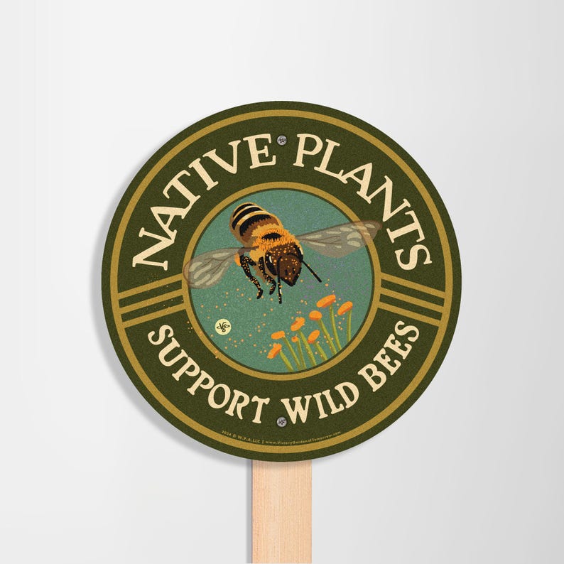 May include: A round green sign with the text "Native Plants Support Wild Bees" and a graphic of a bee pollinating flowers.