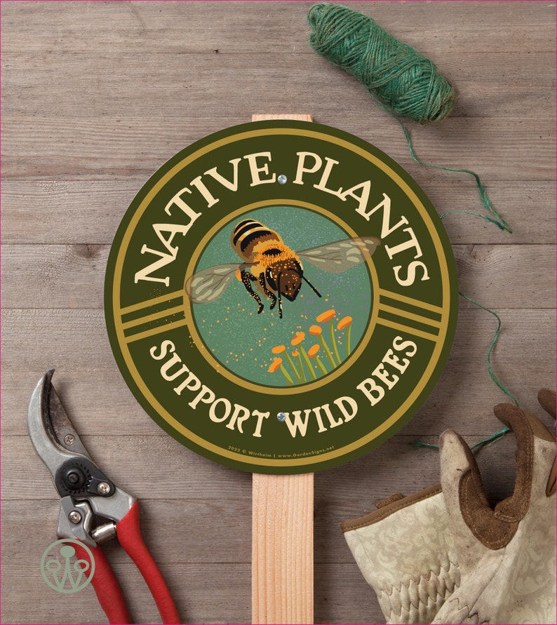 May include: A round green sign with the text "Native Plants Support Wild Bees" in a gold circle. A bee is flying over yellow flowers in the center of the sign.