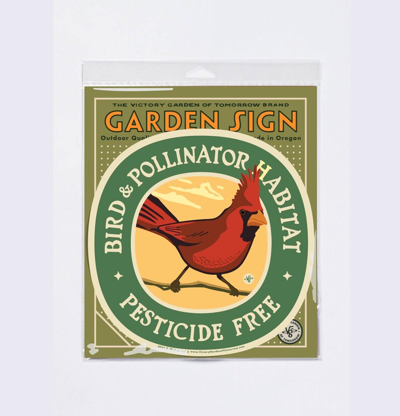 May include: A garden sign featuring a red cardinal bird illustration. The sign reads "Garden Sign" and "Bird & Pollinator Habitat, Pesticide Free". The sign is in a plastic sleeve.
