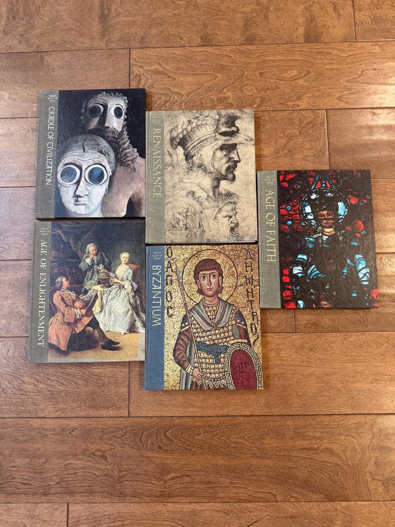 May include: A collection of hardcover books with historical art covers. Titles include "Cradle of Civilization," "Renaissance," "Age of Enlightenment," "Byzantium," and "Age of Faith." The books are arranged on a wooden surface.