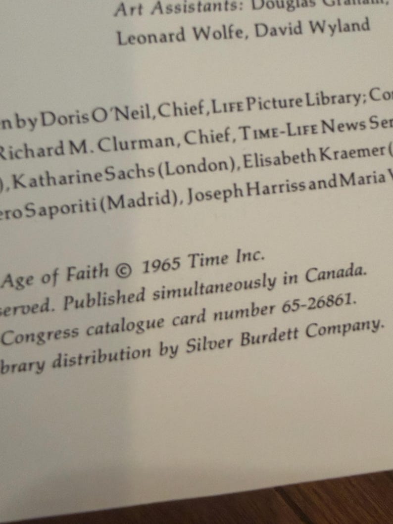 May include: A close-up of a book page with text. The text includes the title "Age of Faith" and the copyright information from 1965 by Time Inc. Other text includes names and titles of people involved in the book's creation and distribution.