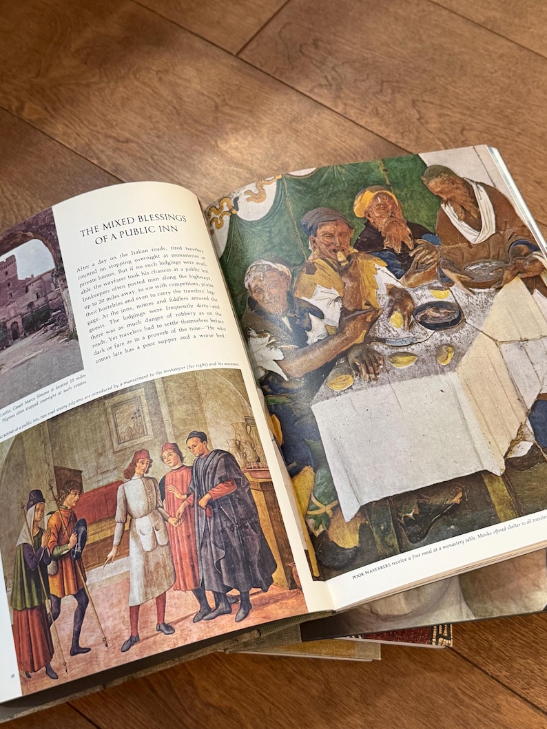 May include: Open book with illustrations of historical scenes. One page features text titled "THE MIXED BLESSINGS OF A PUBLIC INN." The other page shows a colorful depiction of people at a table. The book is open on a wooden surface.