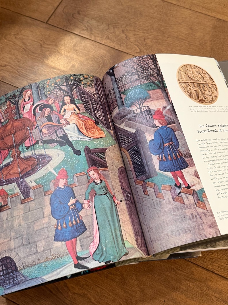 May include: Open book with medieval illustrations. The artwork depicts figures in period clothing, including men in blue tunics and red hats, and women in long gowns. The illustrations are colorful and detailed, with scenes of courtly life and architecture.