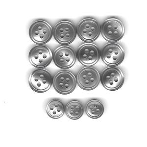May include: A collection of silver-colored buttons arranged on a white background. The buttons are round with four holes and a slightly raised rim. The buttons vary slightly in size.