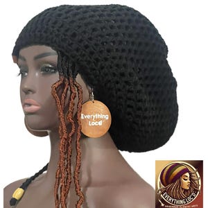 May include: A black crochet slouchy hat with faux locs. The hat is worn by a mannequin with brown skin. The mannequin is wearing a pair of wooden earrings with the text "Everything Loc'd". A logo is in the bottom right corner.