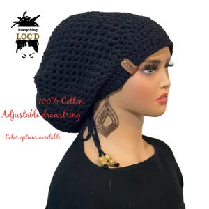 May include: Black crochet beanie with a drawstring and a brown leather tag that says "Everything Loc'd". The beanie is made of 100% cotton and has an adjustable drawstring.