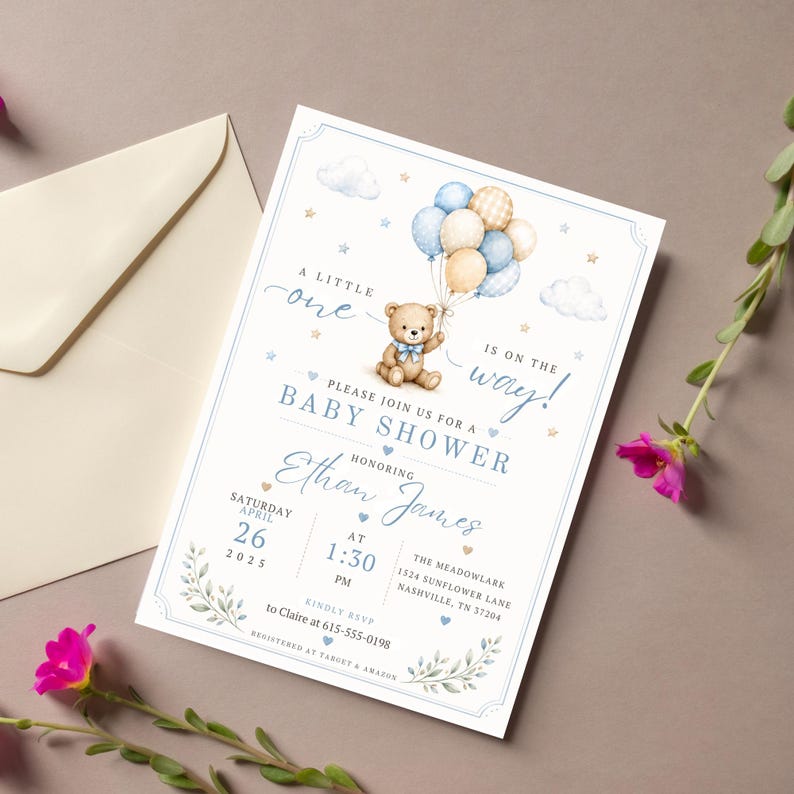 May include: A rectangular baby shower invitation card featuring a watercolor teddy bear holding a cluster of blue, cream, and plaid balloons. The text reads A LITTLE one IS ON THE WAY, PLEASE JOIN US FOR A BABY SHOWER, HONORING Ethan James, SATURDAY APRIL 26 2025 AT 1:30 PM, THE MEADOWLARK 1524 SUNFLOWER LANE NASHVILLE, TN 37204, KINDLY RSVP to Claire at 615-555-0198, REGISTERED AT TARGET & AMAZON.