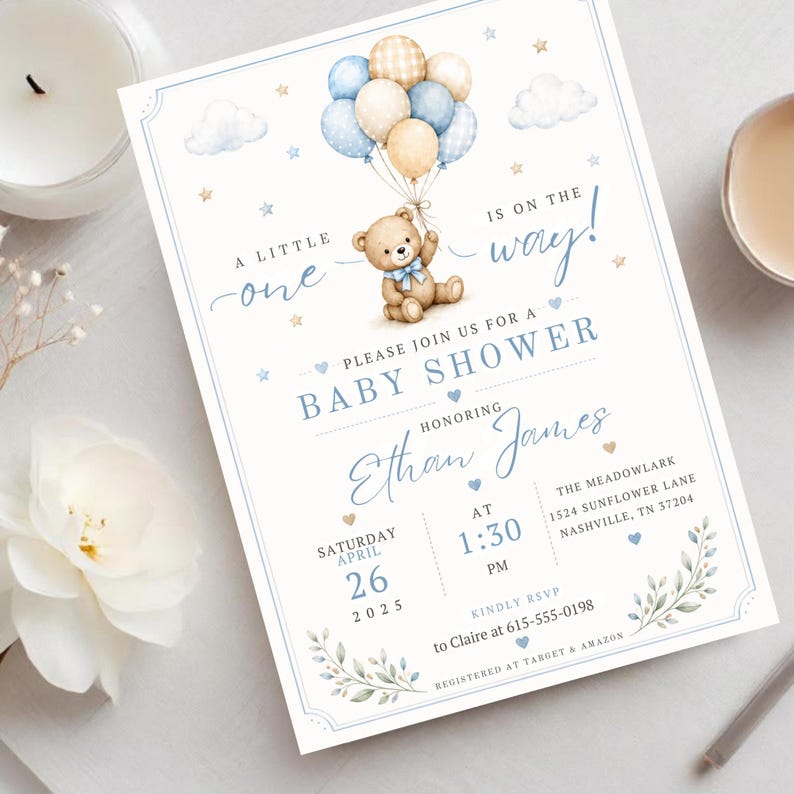 May include: A baby shower invitation card featuring a brown teddy bear holding a cluster of blue, cream, and checkered balloons. The text reads: A little one is on the way! Please join us for a baby shower honoring Ethan James on Saturday, April 26, 2025, at 1:30 PM.