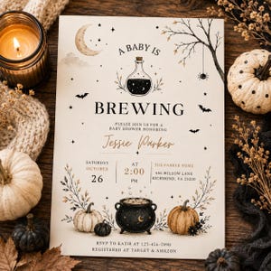 May include: A rectangular baby shower invitation card featuring the text A BABY IS BREWING, a potion bottle, a cauldron, pumpkins, a crescent moon, bats, and a spider. The card includes event details for Jessie Parker on October 26 at 2:00 PM.