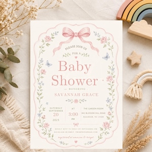 May include: A rectangular baby shower invitation card featuring a pink bow at the top, floral borders with pink roses and blue butterflies, and text including "Please join us for a baby shower honoring Savannah Grace" on a cream-colored background.