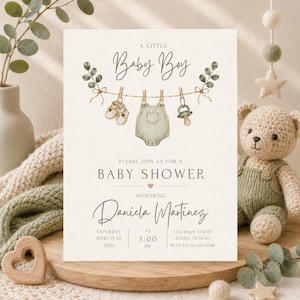 Minimalist baby boy shower invitation featuring sage green watercolor baby clothes, baby shoes, pacifier, eucalyptus greenery, and soft neutral colors. Elegant modern baby shower design with a clean layout, perfect for baby boy showers, gender-neutral celebrations, baby sprinkles, rustic themes, greenery-inspired events, and contemporary baby shower parties. Editable printable invitation template with a timeless and sophisticated aesthetic.