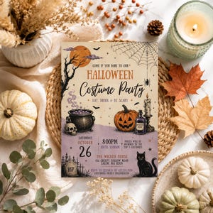 May include: A rectangular Halloween costume party invitation card featuring a full moon, spider web, cauldron, jack-o'-lantern, candle, and black cat. The text reads: Come if you dare to our Halloween Costume Party, Eat, Drink & Be Scary, October 26, 8:00PM.