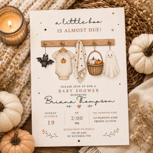 May include: A baby shower invitation card titled A little boo is almost due, featuring a wooden rack with a hanging bat, a baby onesie with a pumpkin, a star-patterned blanket, a basket with pumpkins, and a ghost. Text includes Briana Thompson.