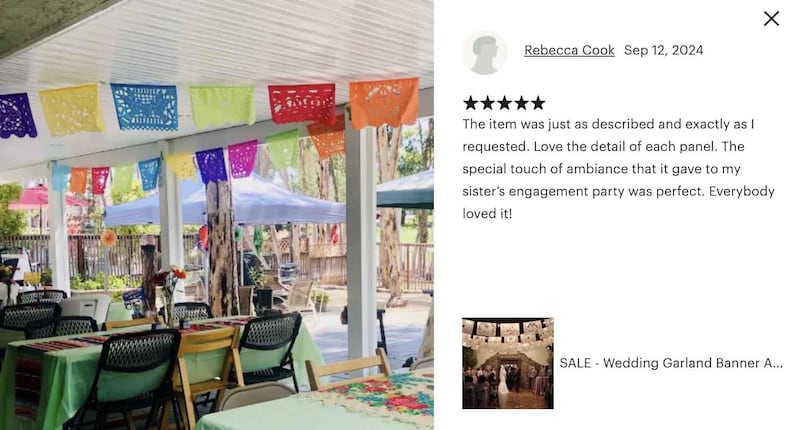 May include: A festive outdoor scene with colorful papel picado banners strung across a covered patio. Tables are set with green tablecloths, and chairs are arranged for a gathering. The scene suggests a celebration or party.