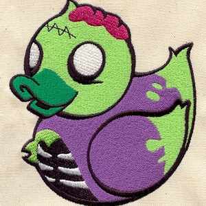 May include: A green and purple rubber duck with a zombie face. The duck has a pink brain showing, stitches on its head, and a skeleton arm on its side.