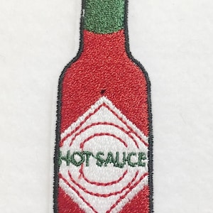 May include: Red and green embroidered hot sauce bottle patch with a white diamond-shaped label that says "HOT SAUCE".