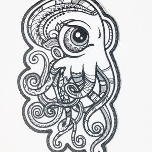 May include: Black and white embroidered patch of an octopus with a large eye and intricate details. The octopus has eight tentacles with swirling patterns.