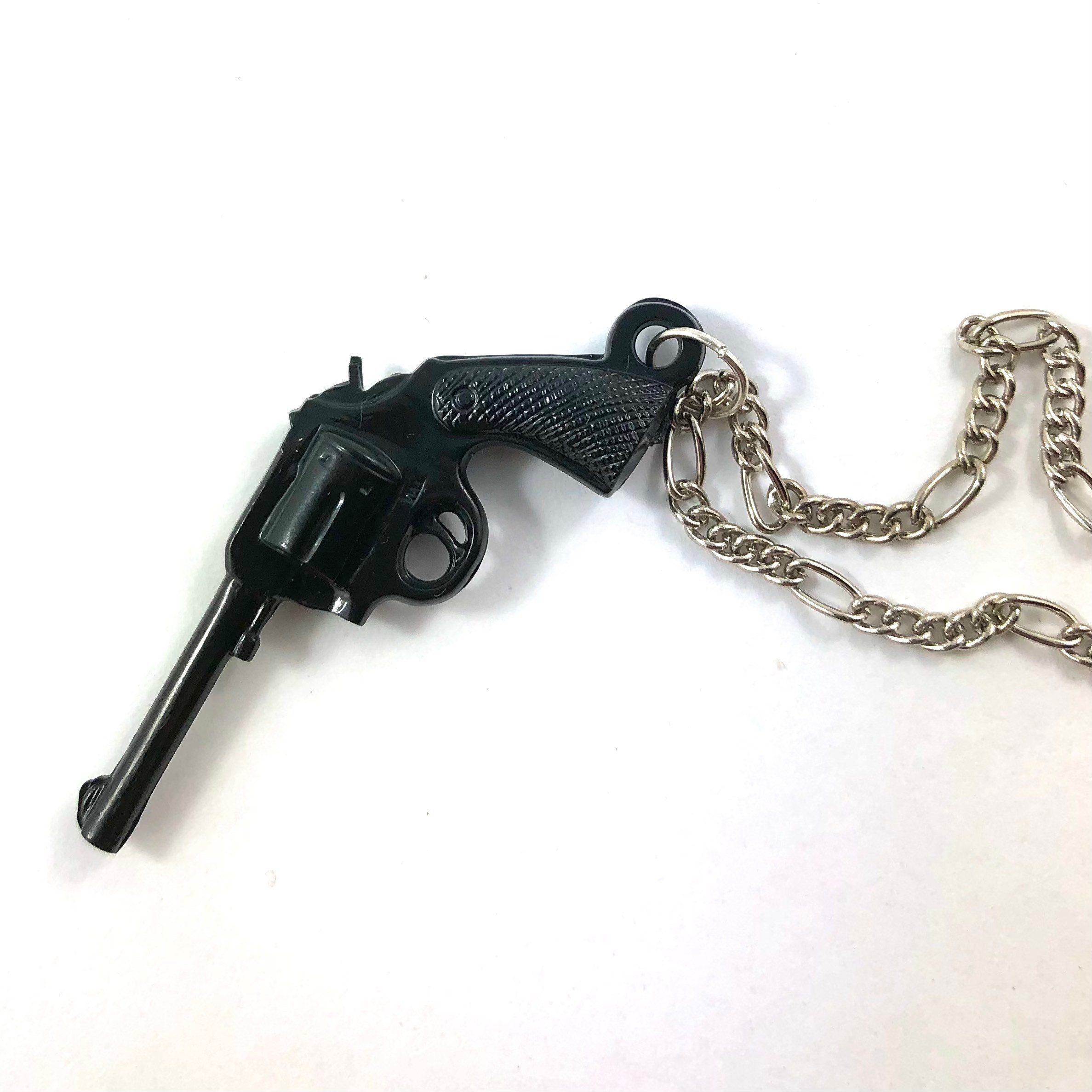Vintage negro juguete pistola revólver plástico gumball premio encanto  colgante collar -  México
