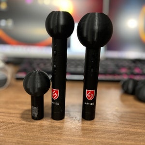 May include: Three black microphones of different sizes with a red logo that says "LA-120".