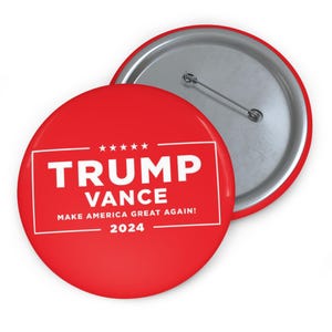 May include: Red button with white text that reads "Trump Vance Make America Great Again! 2024".