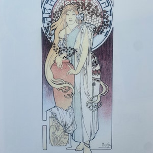 May include: Art Nouveau poster featuring Sarah Bernhardt. The artwork depicts a woman in flowing robes holding a large vase. The poster has a circular design with floral elements and text in French. The artist's signature, Mucha, is visible.