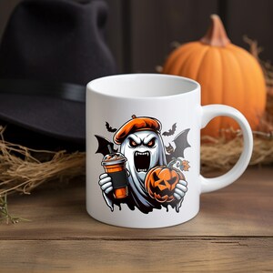 May include: White ceramic mug with a Halloween-themed design featuring a ghost wearing a beret and holding a pumpkin and a cup of coffee. The ghost has a scary expression with fangs and red eyes.
