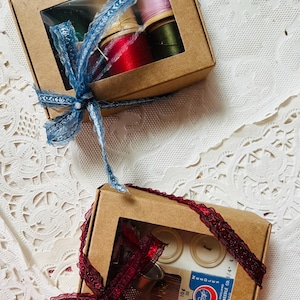 May include: A white ceramic mug with a black handle and the text "But First, Coffee" in a bold, black font. The mug is sitting on a wooden surface. The mug is approximately 4 inches tall.