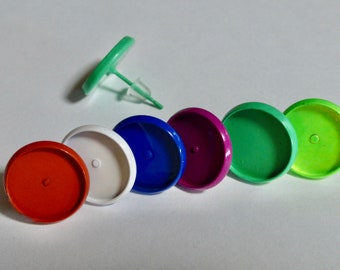 May include: Seven round, flat, blank, colorful, metal, earring bases. The colors are orange, white, blue, purple, green, and lime green.