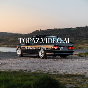 Puede incluir: Un coche negro clásico con llantas blancas está estacionado en un camino de grava. El texto "TOPAZ VIDEO AI" se muestra encima del coche, con "4 Presets + Export Settings" debajo. El fondo presenta un lago y colinas.