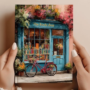 May include: A print of a quaint bookstore with a blue facade, vibrant flowers, and a red bicycle. The shop's window displays rows of books. The text "The Book shop" is above the entrance. A charming scene.