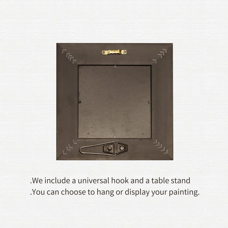 May include: The back of a square, dark brown picture frame with a metal hook and stand. The frame has decorative stitching along the edges. Text at the bottom reads, "We include a universal hook and a table stand. You can choose to hang or display your painting."