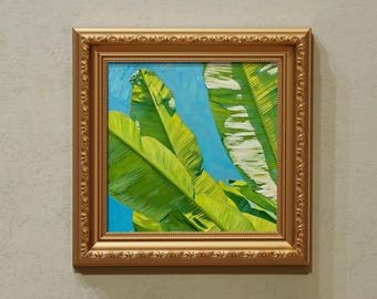 May include: An oil painting in a gold frame, depicting vibrant green banana leaves set against a blue sky. The frame is intricately detailed. The brushstrokes are visible, giving texture to the leaves.