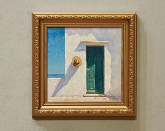 May include: A framed painting depicts a sunlit scene of a white building with a teal door and a straw hat. The painting is in a gold ornate frame, and the sky is a bright blue. The artwork evokes a Mediterranean theme.