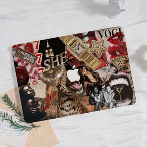 May include: Laptop skin with a collage design. It features a gold watch, leopard print, the word "Vogue", and the text "SHE". The design incorporates red, black, and gold elements.