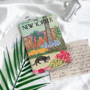 May include: A vintage cover of The New Yorker magazine from June 18, 1960, featuring a black cat walking through a colourful garden with a tree in the background. The cover price is 25 cents.