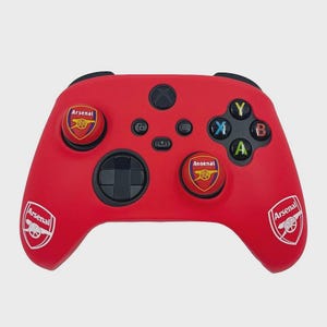 May include: Red Xbox controller with the Arsenal football club emblem. The controller has black buttons and a directional pad. The Arsenal logo is on the thumbsticks and sides. A great gift for any Arsenal fan.