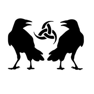 May include: Two black raven silhouettes face each other, with a Celtic knot symbol between them. The ravens are detailed with open beaks and visible legs. The background is plain white.