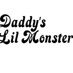 May include: Black and white graphic text that reads "Daddy's Lil Monster" in a retro font style.