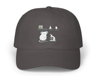 May include: A dark gray baseball cap featuring an embroidered graphic of a white rat, a microscope, test tubes, and a flask. The text "Certified Lab Rat" is printed in a dark font above the rat illustration, centered on the front panel.