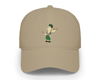 May include: A tan baseball cap featuring a cartoon character wearing a dark green beret, a grey vest, and green pants. The character holds a wooden spoon in one hand and a colorful artist palette in the other, standing against the solid tan fabric.