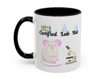 May include: A white ceramic mug with a black handle and interior rim. The exterior features a graphic of a white mouse, a microscope, test tubes, and a flask, with the black text "Certified Lab Rat" printed across the centre of the mug.