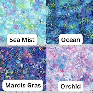 May include: Four fabric swatches with geometric patterns in shades of blue, green, purple, and pink. The swatches are labeled "Sea Mist", "Ocean", "Mardis Gras", and "Orchid".