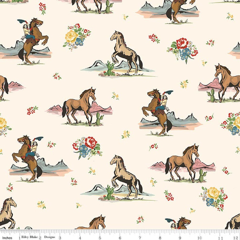 May include: Cream-coloured fabric with a repeating pattern of horses, cowboys, cacti, mountains, and floral bouquets. The horses are shown in different poses, including rearing up. The design has a vintage, Western aesthetic.