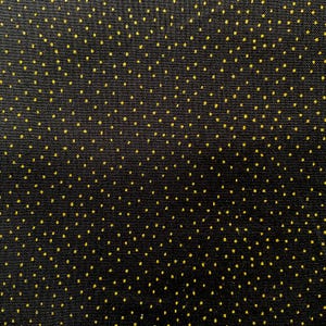 May include: Close-up of a black fabric with a repeating pattern of small, evenly spaced yellow dots. The dots are scattered across the surface, creating a textured appearance. The fabric has a subtle sheen.