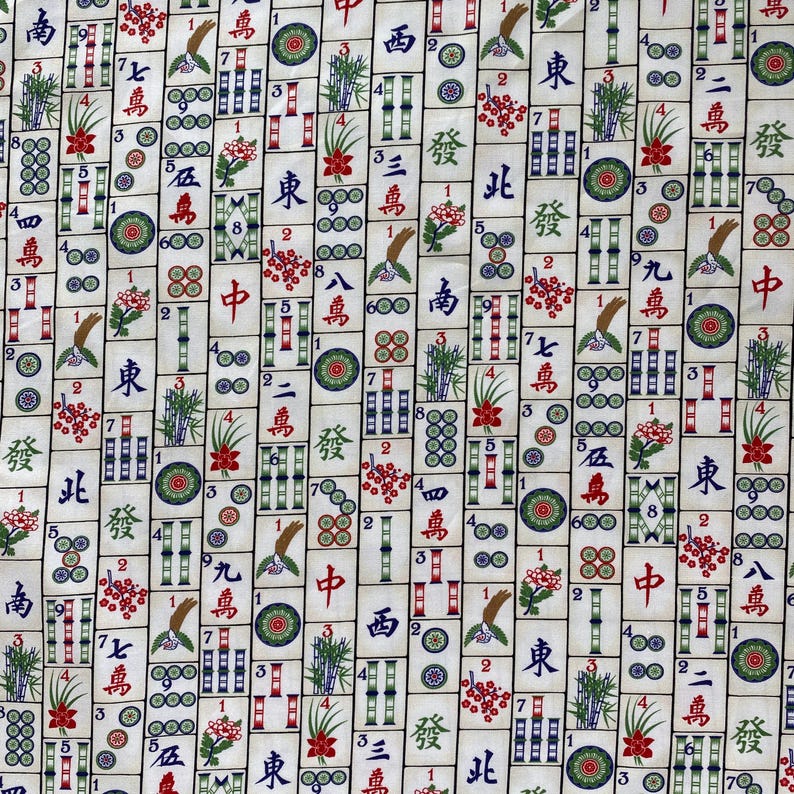 May include: A fabric with a repeating pattern of Mahjong tiles. The tiles are cream-colored with black, red, green, and blue symbols and characters. The design includes flowers, bamboo, and circles.